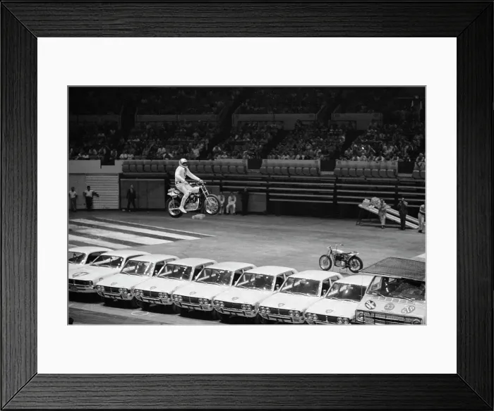 Framed Print : Evel Knievel Jumping Motorcycle over Cars Framed Print : Evel Knievel Jumping Motorcycle over Cars