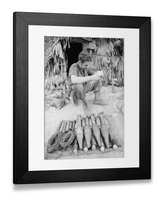 Framed Print : Soldier Seated Near Rockets Reading Framed Print : Soldier Seated Near Rockets Reading