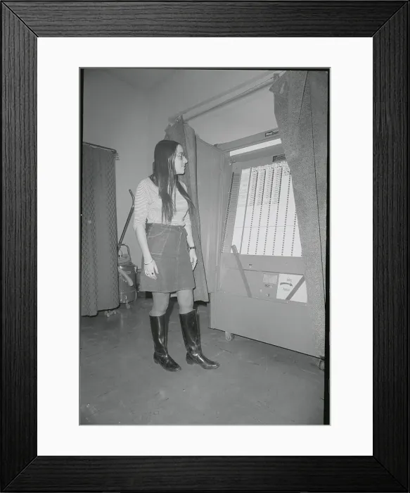 Framed Print : Young Woman Observing Voting Machine Framed Print : Young Woman Observing Voting Machine