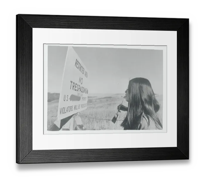Framed Print : Young Native American Painting over Government Sign Framed Print : Young Native American Painting over Government Sign