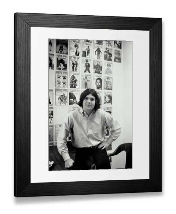 Framed Print : Jann Wenner Posing with Rolling Stone Covers