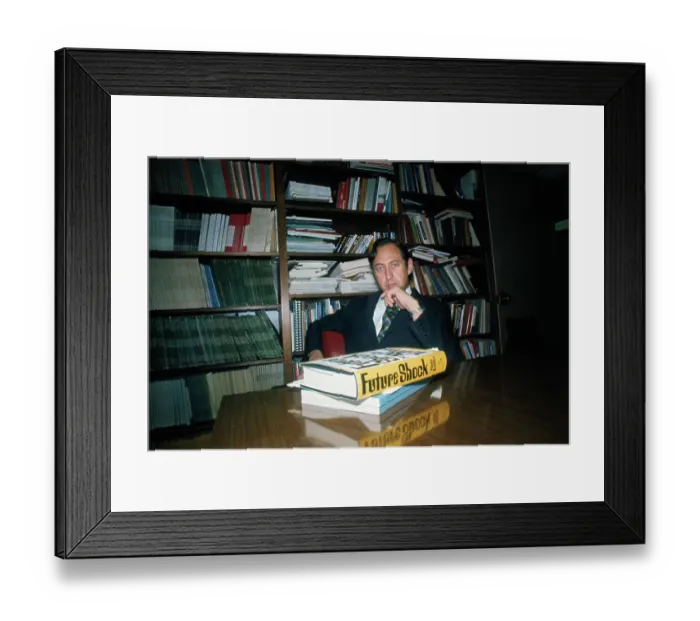 Framed Print : Alvin Toffler Posing at Desk