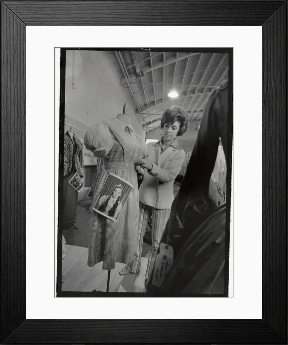 Framed Print : Judy Carroll Putting Tag on A Dress Framed Print : Judy Carroll Putting Tag on A Dress
