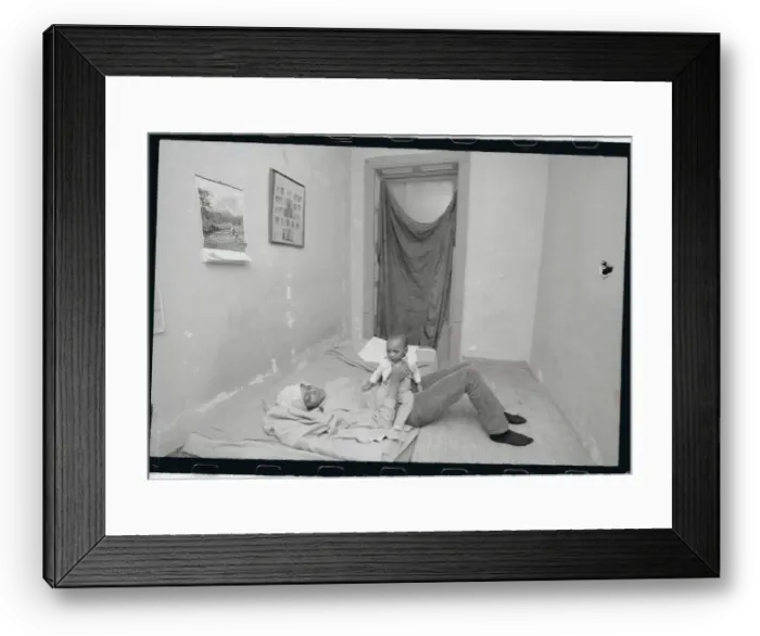 Framed Print : Mother and Child Playing in Poorly Furnished Bedroom Framed Print : Mother and Child Playing in Poorly Furnished Bedroom