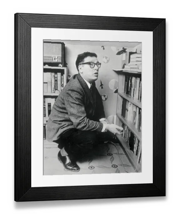 Framed Print : Writer Isaac Asimov Squatting by Bookcase Framed Print : Writer Isaac Asimov Squatting by Bookcase