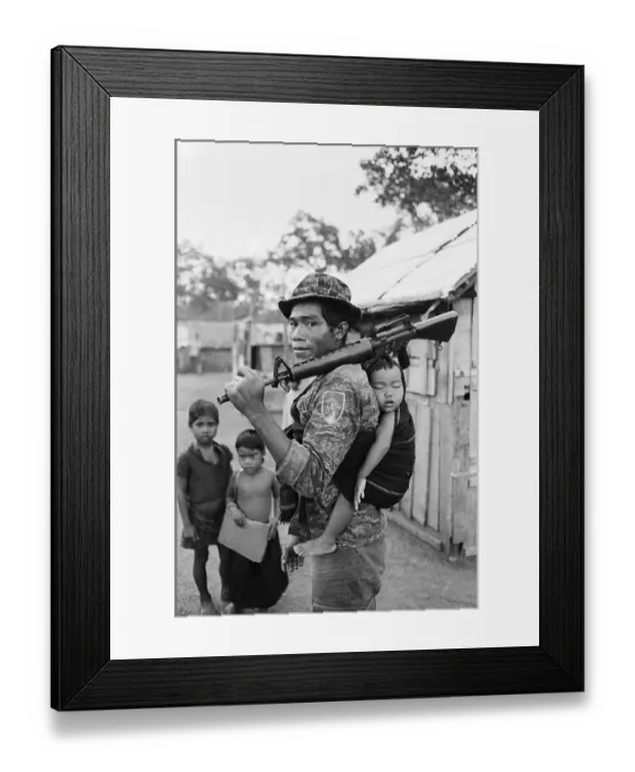 Framed Print : Montagnard Soldier Carrying Baby Framed Print : Montagnard Soldier Carrying Baby