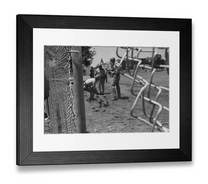 Framed Print : Police Drag Protester, View Through Fence
