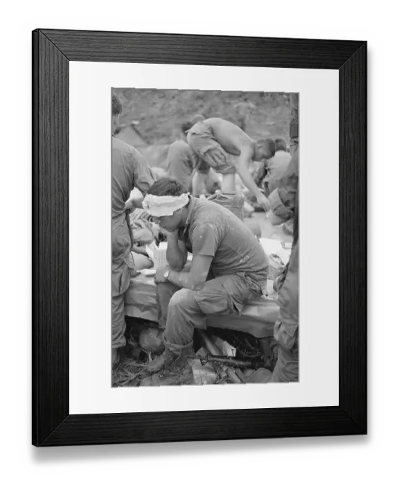 Framed Print : An Injured Soldier Waits For Helicopter Framed Print : An Injured Soldier Waits For Helicopter