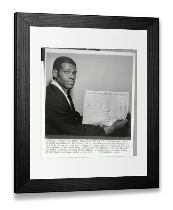 Framed Print : Bob Gibson Holding Newspaper Framed Print : Bob Gibson Holding Newspaper