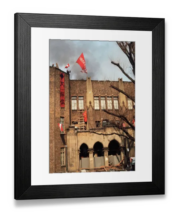 Framed Print : Student Waving Flag from Top of Building Framed Print : Student Waving Flag from Top of Building