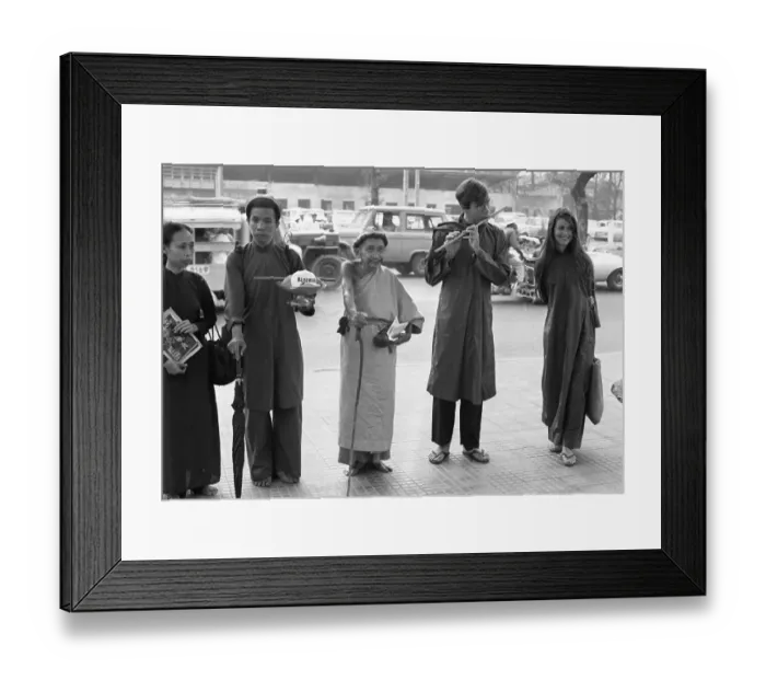 Framed Print : Nguyen Thanh Nam and John Steinbeck IV Plays Flute Outside U.S. Embassy