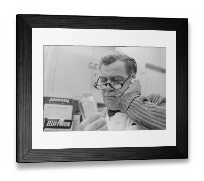 Framed Print : Man Holding Pills While Taking His Temperature Framed Print : Man Holding Pills While Taking His Temperature