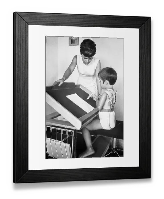 Framed Print : Mother Watches Child Write with False Limbs Framed Print : Mother Watches Child Write with False Limbs