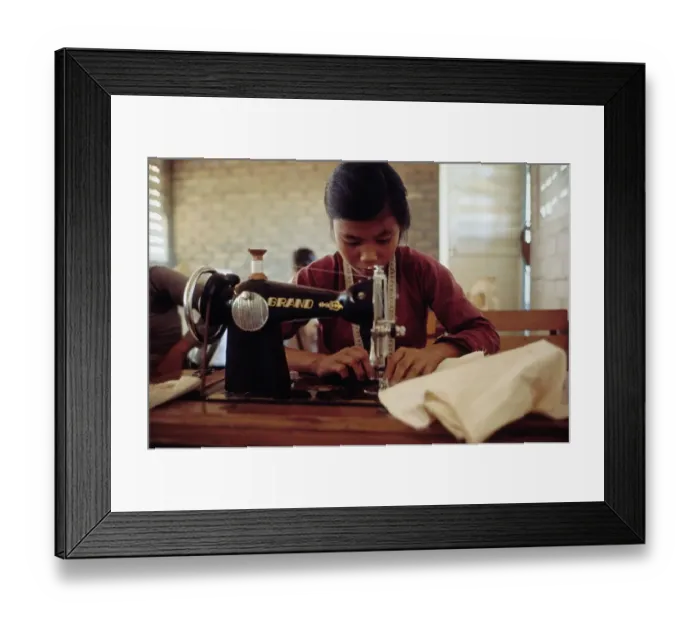 Framed Print : Woman Using Sewing Machine Framed Print : Woman Using Sewing Machine