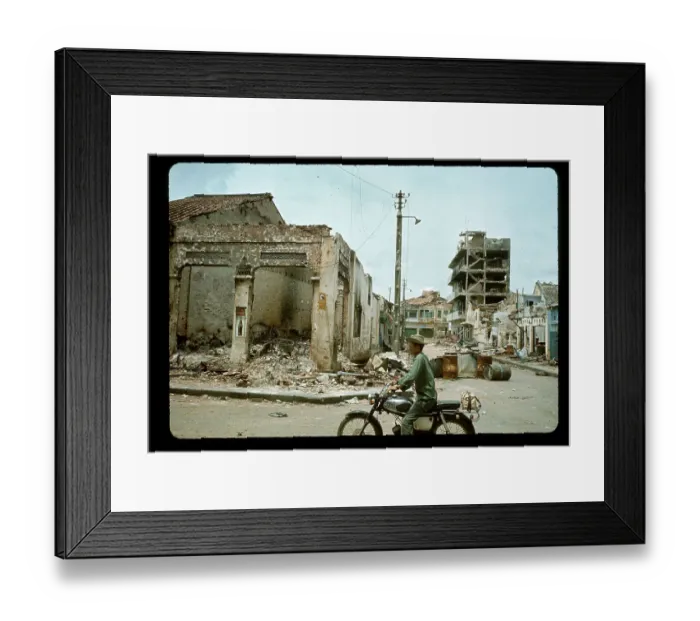 Framed Print : Man on Moped Rides Past Bombed Building Framed Print : Man on Moped Rides Past Bombed Building
