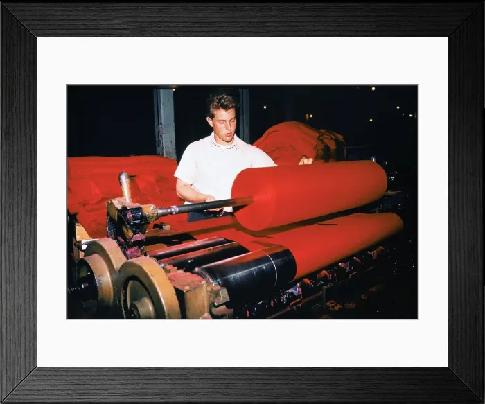 Framed Print : Workman Placing Bolts of Cloth on Roller Machine Framed Print : Workman Placing Bolts of Cloth on Roller Machine