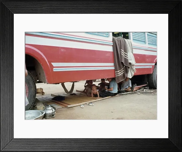 Framed Print : Refugees Sheltering Under Truck Framed Print : Refugees Sheltering Under Truck