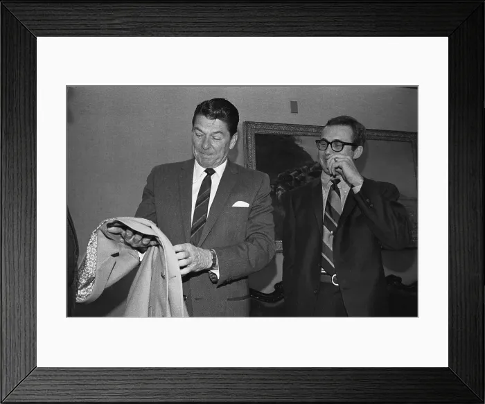 Framed Print : Ronald Reagan Examining Jacket and Tie Framed Print : Ronald Reagan Examining Jacket and Tie