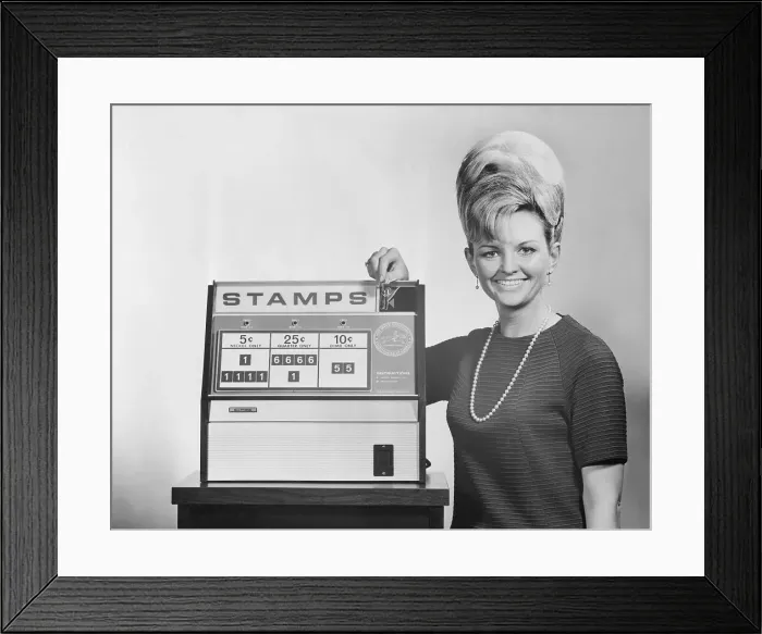 Framed Print : Woman Standing by Stamp Machine Framed Print : Woman Standing by Stamp Machine