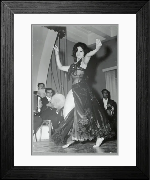 Framed Print : Woman Dancing in Front of Men Framed Print : Woman Dancing in Front of Men