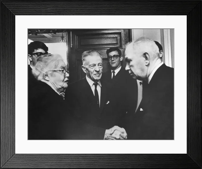Framed Print : Man Greeting Elderly Couple Framed Print : Man Greeting Elderly Couple