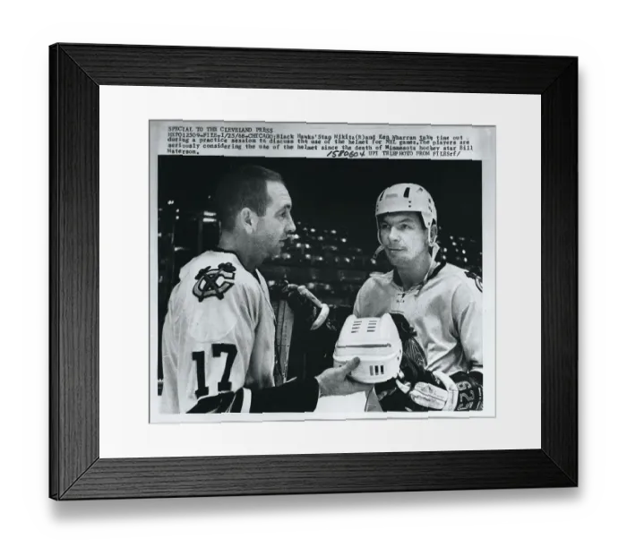Framed Print : Hockey Teammates Examining Helmet Framed Print : Hockey Teammates Examining Helmet