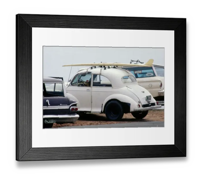 Framed Print : Surf Car. A surfboard mounted on the roof rack of a Morris Minor car at a beach in Hawaii Framed Print : Surf Car. A surfboard mounted on the roof rack of a Morris Minor car at a beach in Hawaii