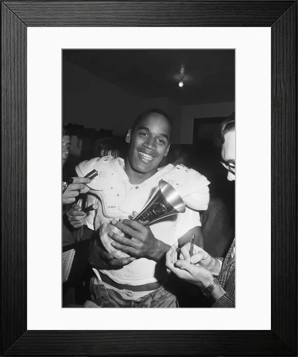 Framed Print : O.J. Simpson Holding Player of the Game Trophy Framed Print : O.J. Simpson Holding Player of the Game Trophy