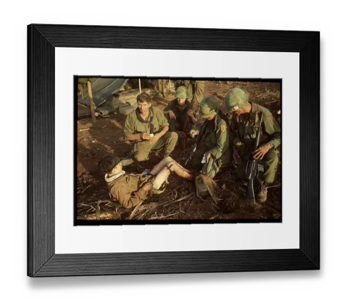 Framed Print : US Medic Dressing Leg of Captured Viet Cong