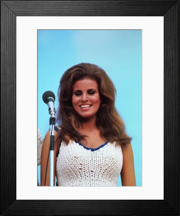 Framed Print : Raquel Welch Standing Behind a Microphone Framed Print : Raquel Welch Standing Behind a Microphone