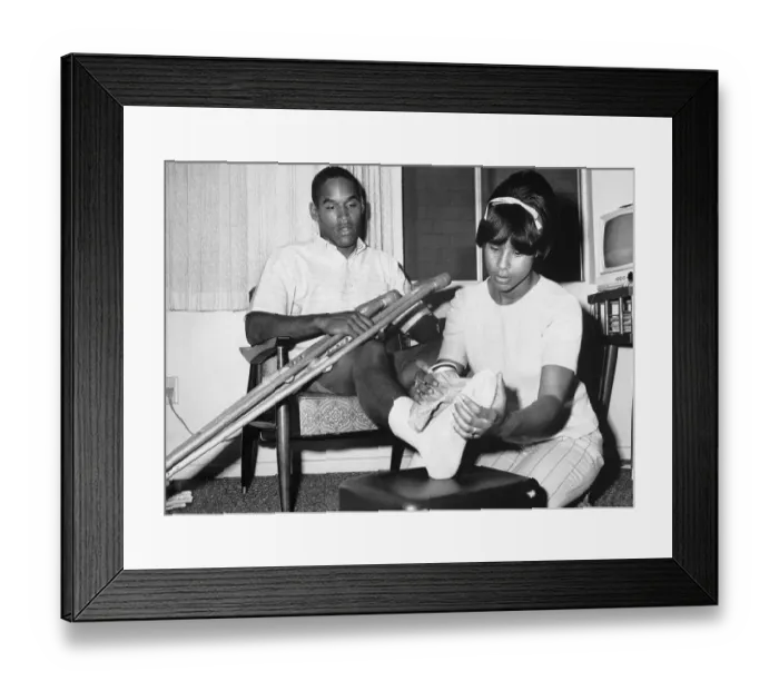 Framed Print : O.J. Simpson's Wife Applies an Ice Pack to His Foot Framed Print : O.J. Simpson's Wife Applies an Ice Pack to His Foot
