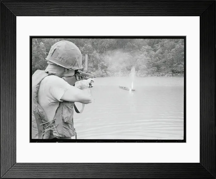 Framed Print : Soldier Shooting a Sampan Framed Print : Soldier Shooting a Sampan