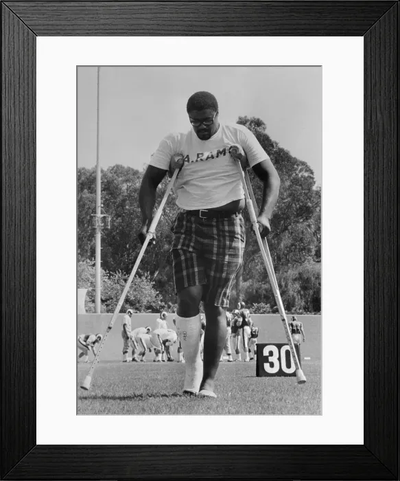 Framed Print : Rosey Grier Walking on Crutches Framed Print : Rosey Grier Walking on Crutches