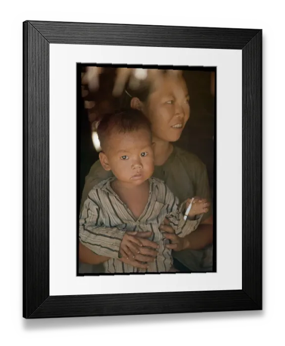 Framed Print : Vietnamese Child Smoking on Mother's Lap Framed Print : Vietnamese Child Smoking on Mother's Lap