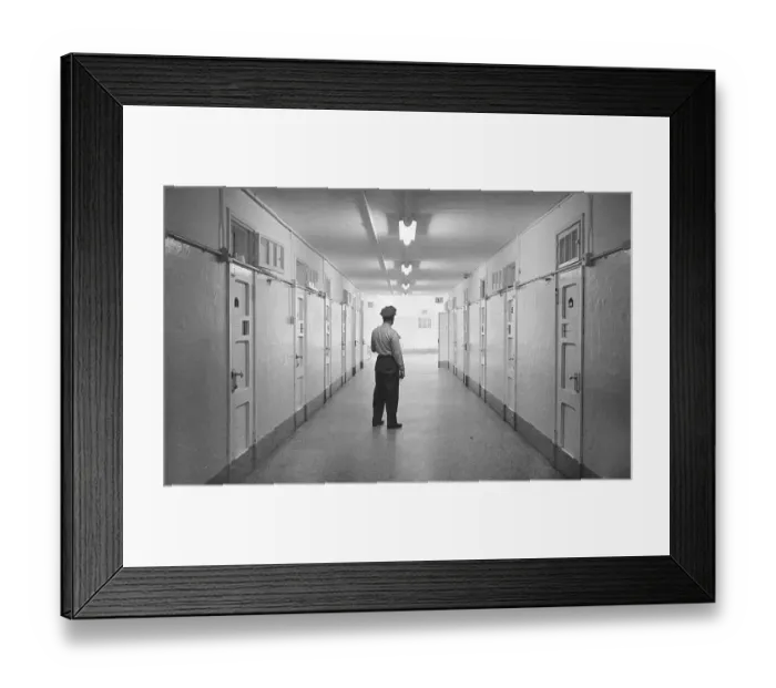 Framed Print : Officer Standing in Hallway of Prison Framed Print : Officer Standing in Hallway of Prison
