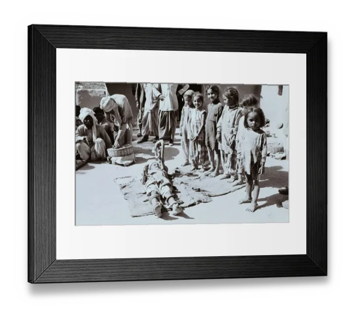 Framed Print : Girls Watching Boy Play With Snakes Framed Print : Girls Watching Boy Play With Snakes