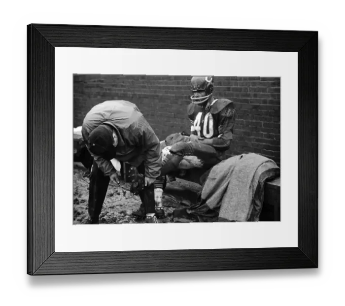 Framed Print : Trainer Cleans Gale Sayers Spikes During Football Game Framed Print : Trainer Cleans Gale Sayers Spikes During Football Game