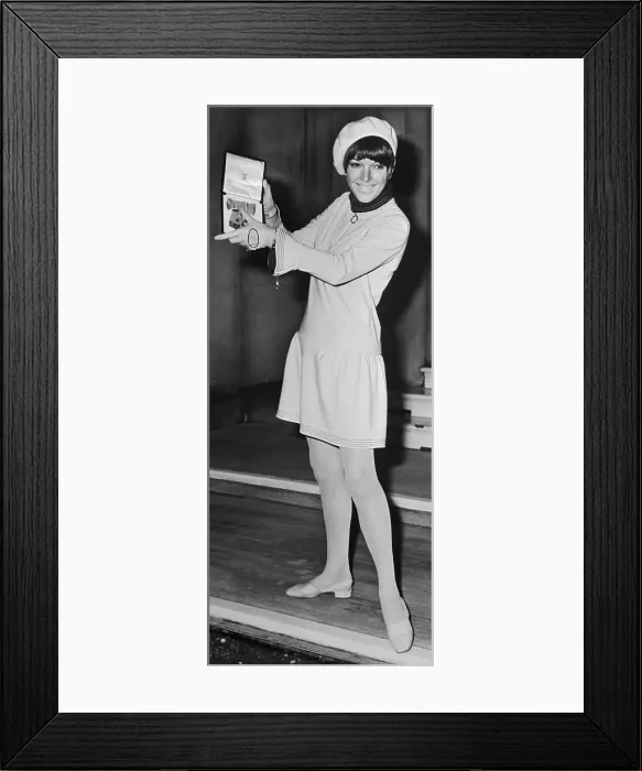 Framed Print : Mary Quant in Miniskirt and Holding her O.B.E Framed Print : Mary Quant in Miniskirt and Holding her O.B.E