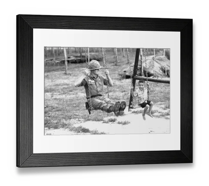 Framed Print : U.S. Soldier and Vietnamese Child on Swingset Framed Print : U.S. Soldier and Vietnamese Child on Swingset