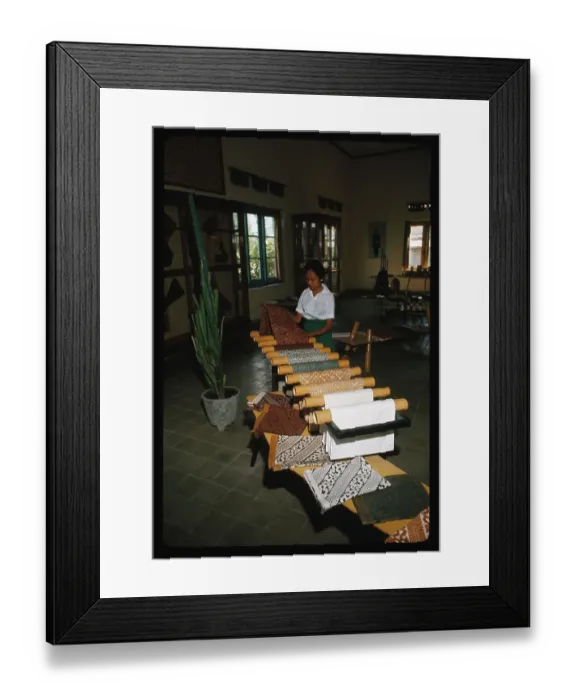 Framed Print : Woman Unrolling Batik Material