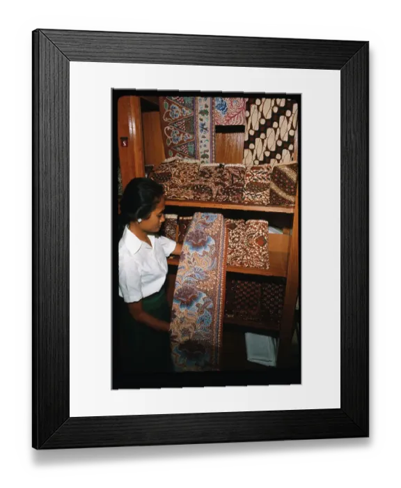 Framed Print : Woman Showing Batik Material Framed Print : Woman Showing Batik Material