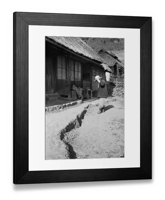 Framed Print : Man Studies Large Crack In Earth By Home Framed Print : Man Studies Large Crack In Earth By Home