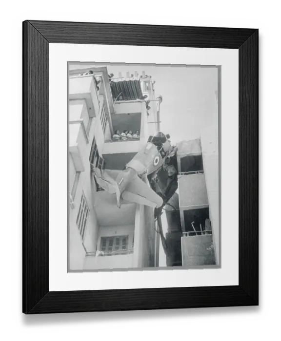 Framed Print : Plane Wreckage Caught Between Buildings
