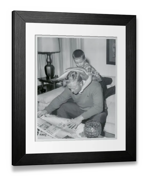 Framed Print : Jack Nicklaus Reading Newspaper with Son on His Back Framed Print : Jack Nicklaus Reading Newspaper with Son on His Back