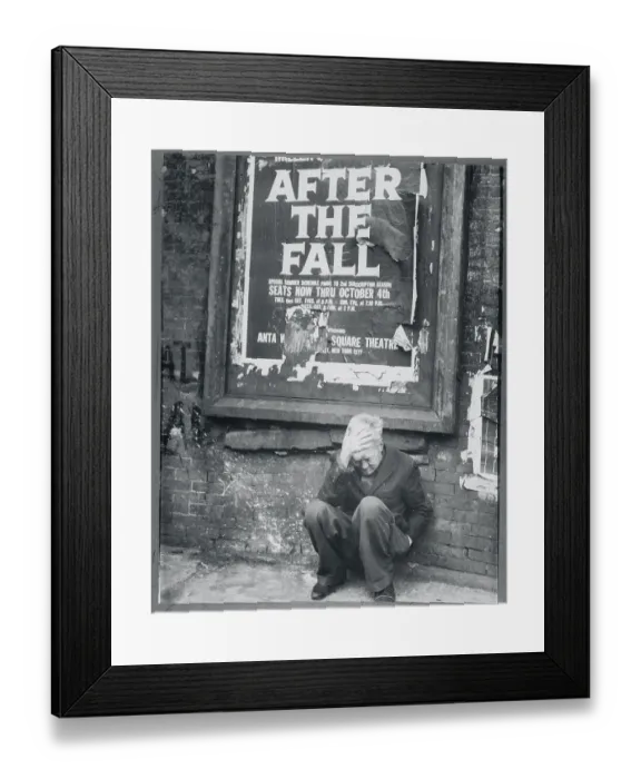 Framed Print : Man Crouching Beneath a Tattered Poster Framed Print : Man Crouching Beneath a Tattered Poster