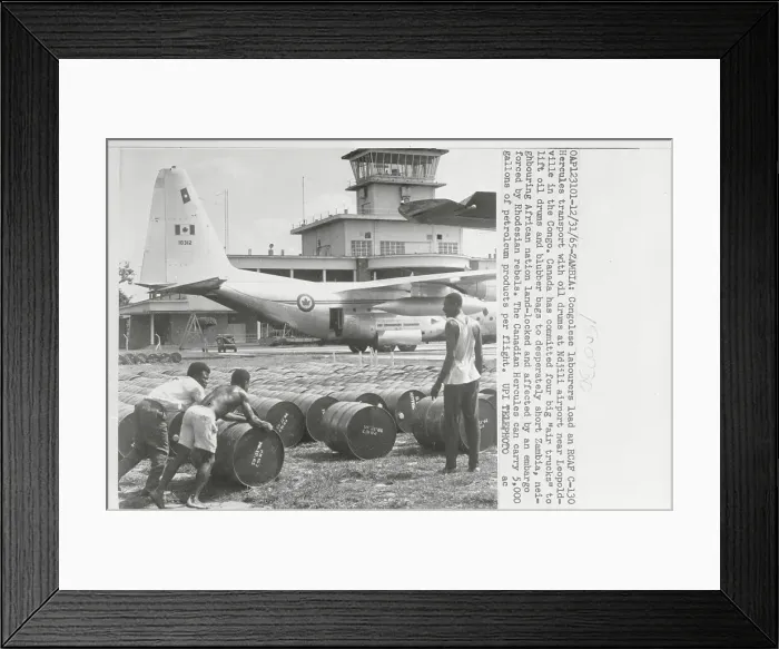 Framed Print : Industry Workers Moving Cannisters on Airport Grounds Framed Print : Industry Workers Moving Cannisters on Airport Grounds