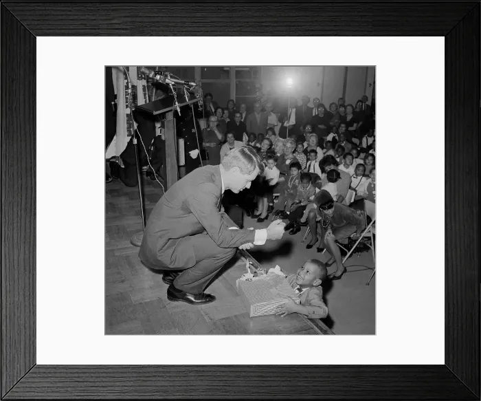 Framed Print : Robert Kennedy Giving a Present to a Young Boy Framed Print : Robert Kennedy Giving a Present to a Young Boy