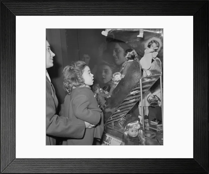 Framed Print : Girl Being Raised to Gaze into Window at Doll Framed Print : Girl Being Raised to Gaze into Window at Doll