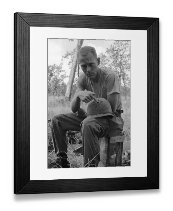 Framed Print : Soldier Displaying Bullet Hole in Helmet Framed Print : Soldier Displaying Bullet Hole in Helmet