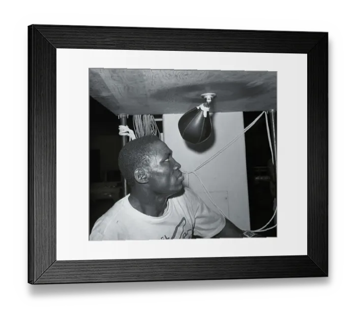 Framed Print : Dick Tiger Practicing on Punching Equipment